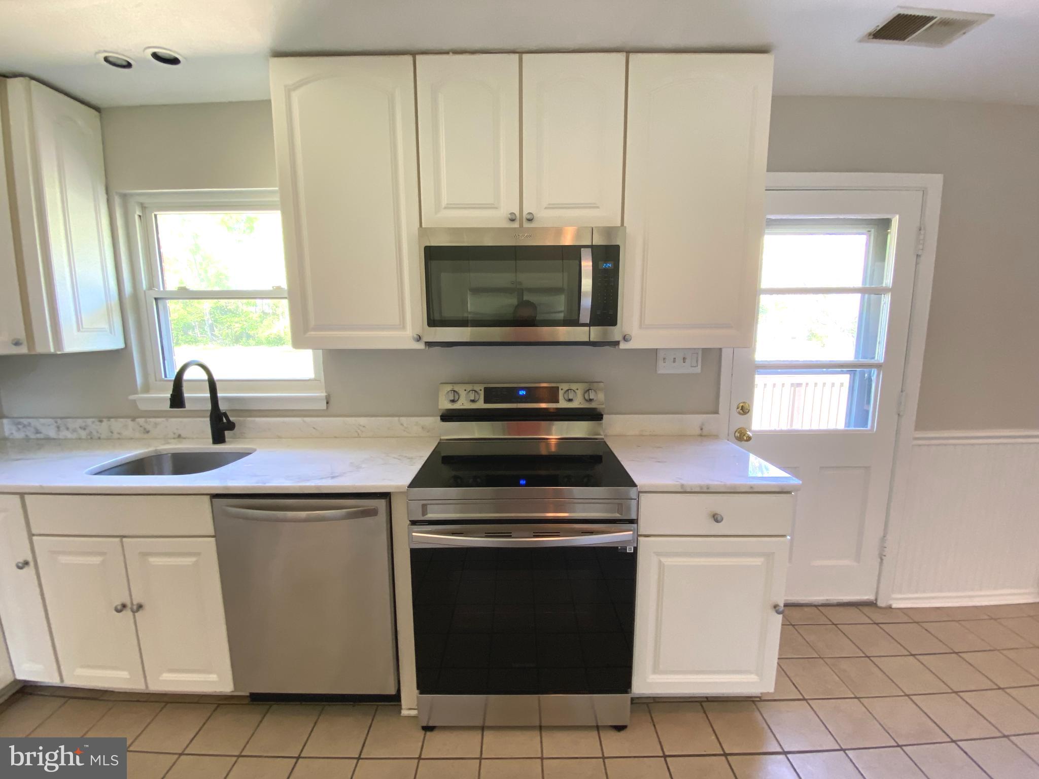 5072 Rock Springs Road Warrenton, VA 20187 - Photo 5 of 28 a kitchen with a stove sink and microwave