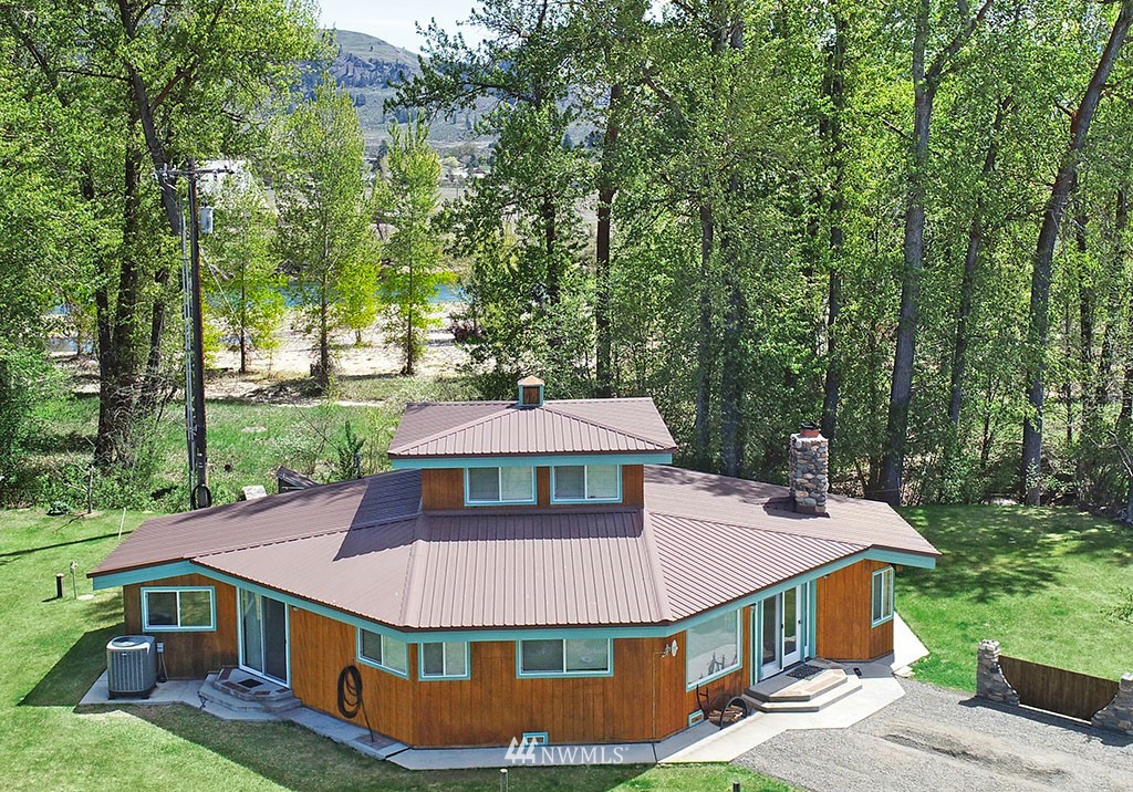 26 Beaver Pond Road Twisp, WA 98856 - Photo 2 of 31 an aerial view of a house with yard and trees in the background