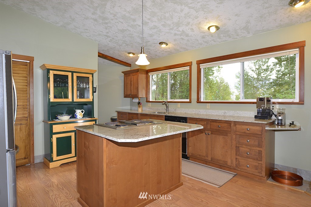 26 Beaver Pond Road Twisp, WA 98856 - Photo 11 of 31 a kitchen with stainless steel appliances granite countertop a sink stove and cabinets