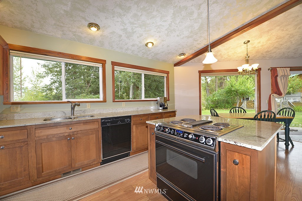 26 Beaver Pond Road Twisp, WA 98856 - Photo 13 of 31 a kitchen with stainless steel appliances granite countertop a stove a sink and a microwave
