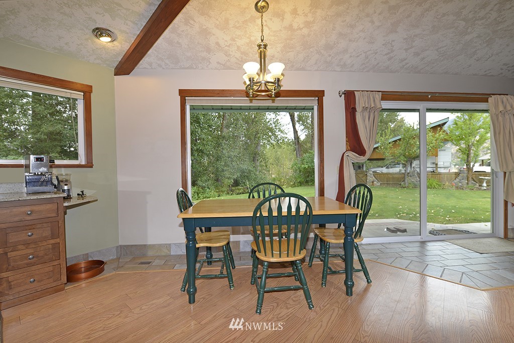 26 Beaver Pond Road Twisp, WA 98856 - Photo 14 of 31 a dining room with furniture a chandelier and wooden floor