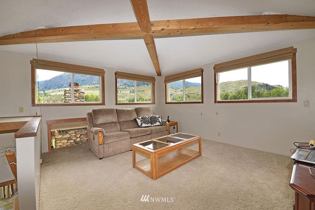 26 Beaver Pond Road Twisp, WA 98856 - Photo 15 of 31 a living room with furniture a window and a flat screen tv