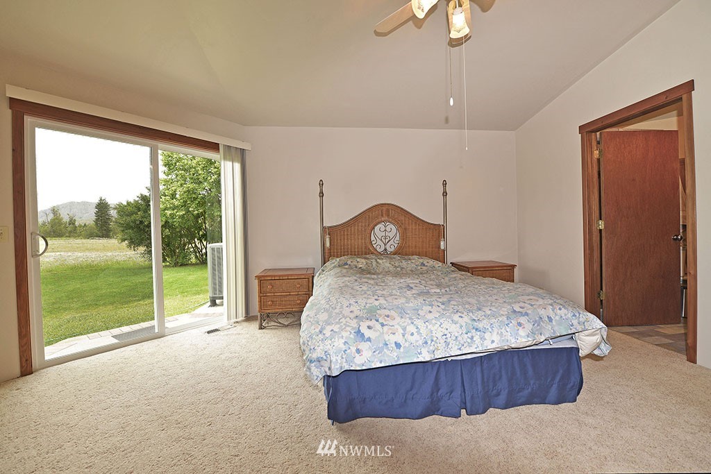 26 Beaver Pond Road Twisp, WA 98856 - Photo 17 of 31 a bedroom with a bed and a large window