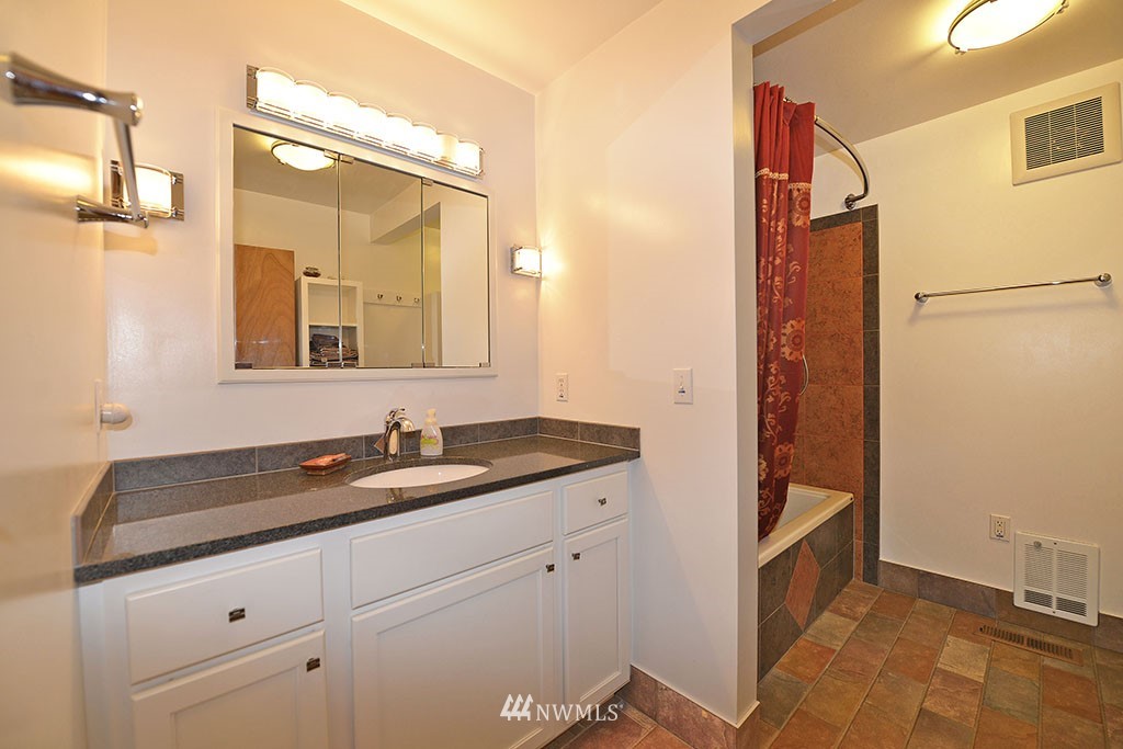 26 Beaver Pond Road Twisp, WA 98856 - Photo 22 of 31 a bathroom with a granite countertop sink and a mirror