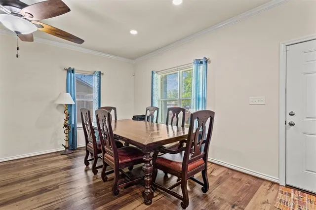 a view of a dining room with furniture and wooden floor