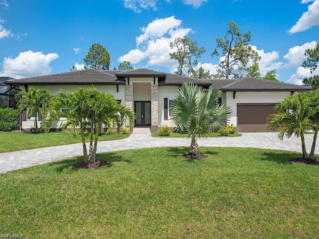 710 Soll Street Naples, FL 34109 - Photo 1 of 12 a front view of a house with garden