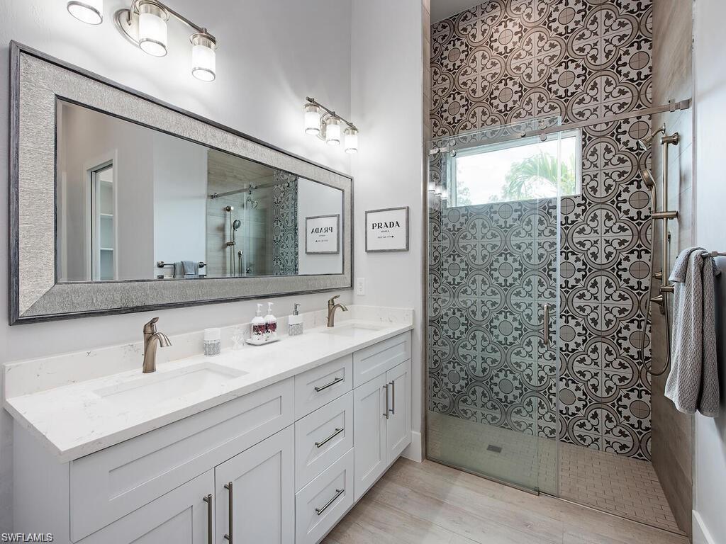 710 Soll Street Naples, FL 34109 - Photo 12 of 12 a bathroom with a sink a toilet and shower