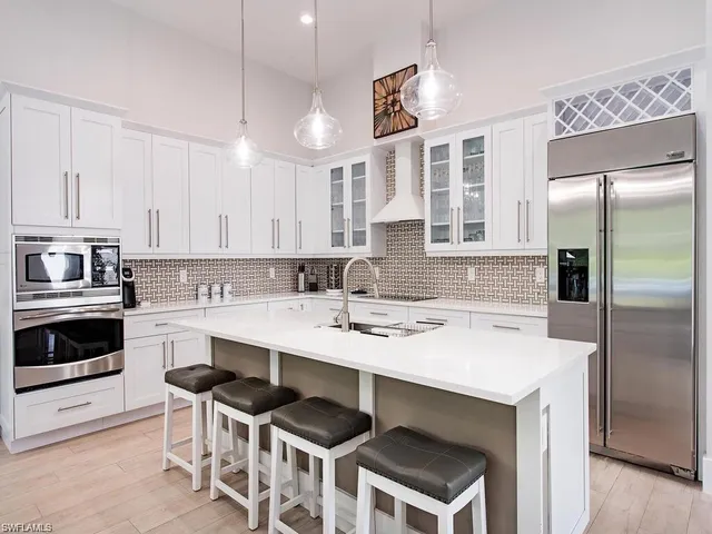 a kitchen with a stove a sink and a refrigerator