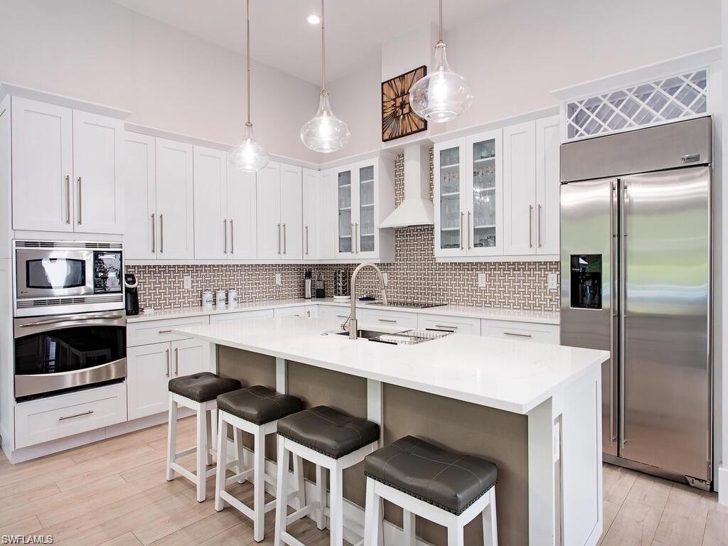 710 Soll Street Naples, FL 34109 - Photo 7 of 12 a kitchen with a stove a sink and a refrigerator