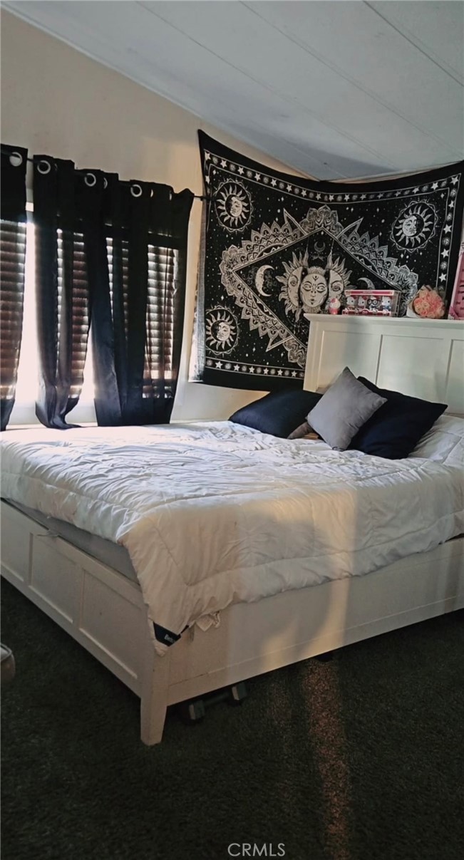 20683 Waalew Road, Unit B190 Apple Valley, CA 92307 - Photo 18 of 26 a bedroom with a bed window and a mirror