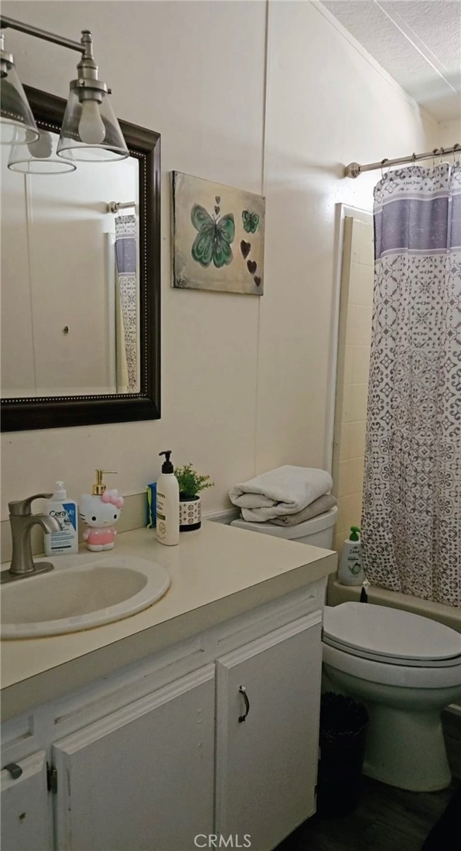 20683 Waalew Road, Unit B190 Apple Valley, CA 92307 - Photo 20 of 26 a bathroom with a sink a toilet and shower