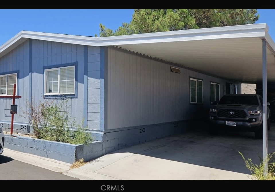 20683 Waalew Road, Unit B190 Apple Valley, CA 92307 - Photo 2 of 26 a view of backyard with wheel chair potted plants