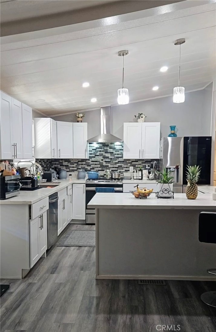 20683 Waalew Road, Unit B190 Apple Valley, CA 92307 - Photo 4 of 26 a large kitchen with kitchen island a stove a sink a refrigerator and white cabinets