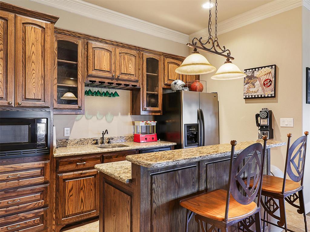 1200 McReynolds Road Sanger, TX 76266 - Photo 17 of 20 a kitchen with stainless steel appliances granite countertop a sink and cabinets