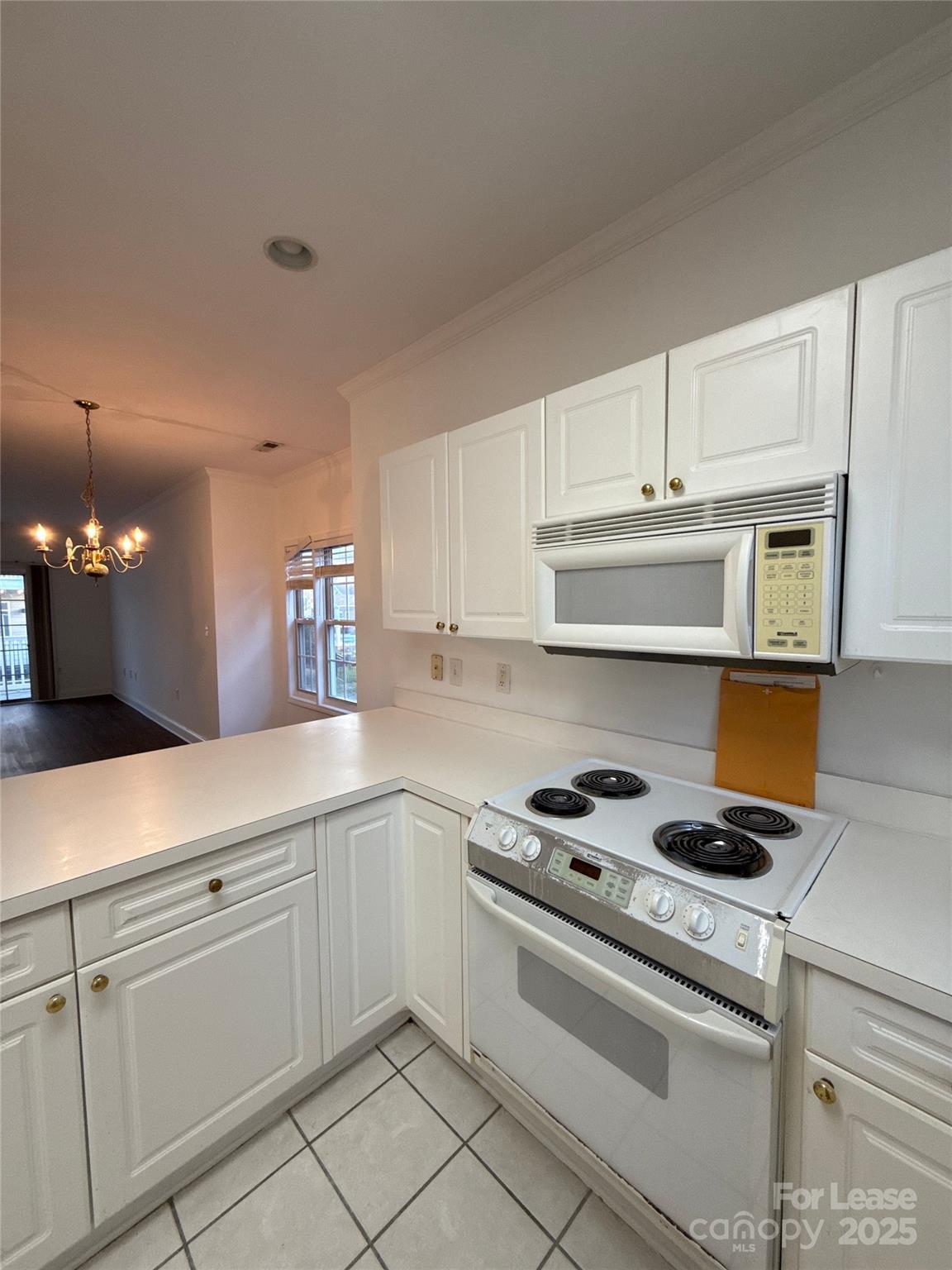 9068 Meadow Vista Road Charlotte, NC 28213 - Photo 3 of 13 a kitchen with white cabinets and appliances