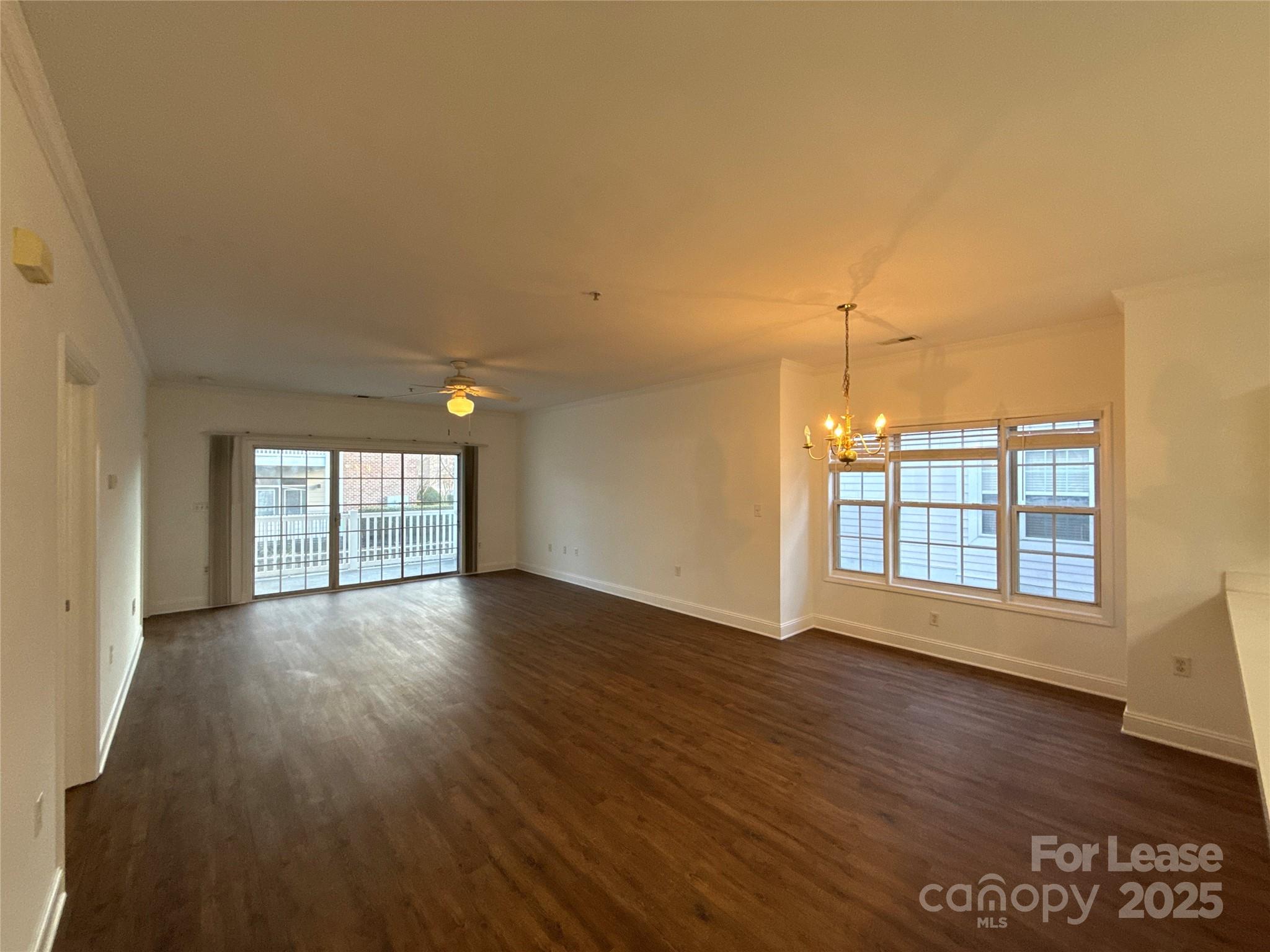 9068 Meadow Vista Road Charlotte, NC 28213 - Photo 5 of 13 an empty room with wooden floor and windows