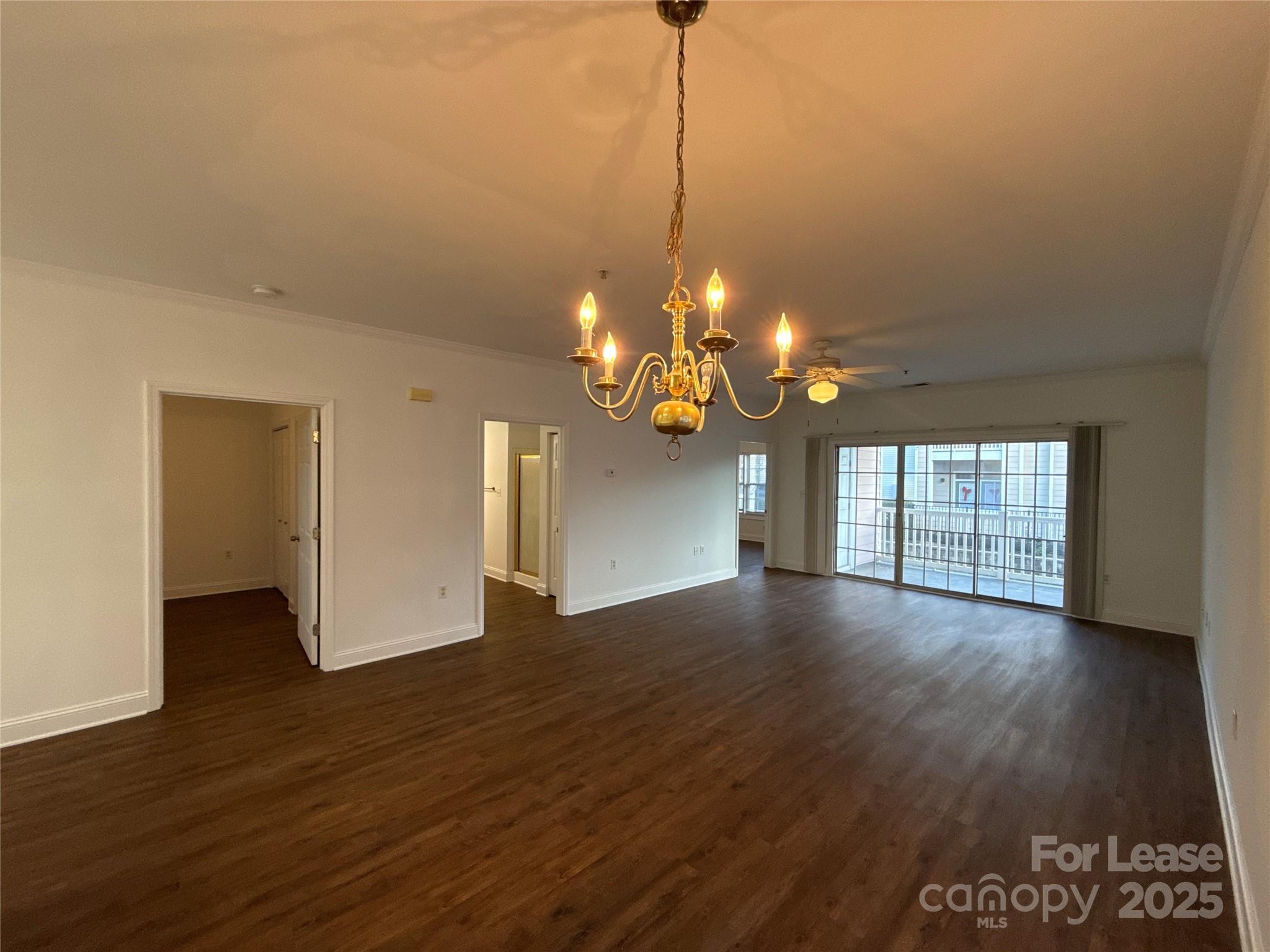 9068 Meadow Vista Road Charlotte, NC 28213 - Photo 6 of 13 a view of a room with wooden floor and chandelier