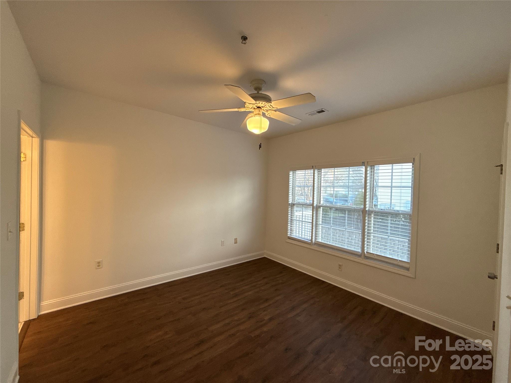 9068 Meadow Vista Road Charlotte, NC 28213 - Photo 7 of 13 an empty room with wooden floor and windows
