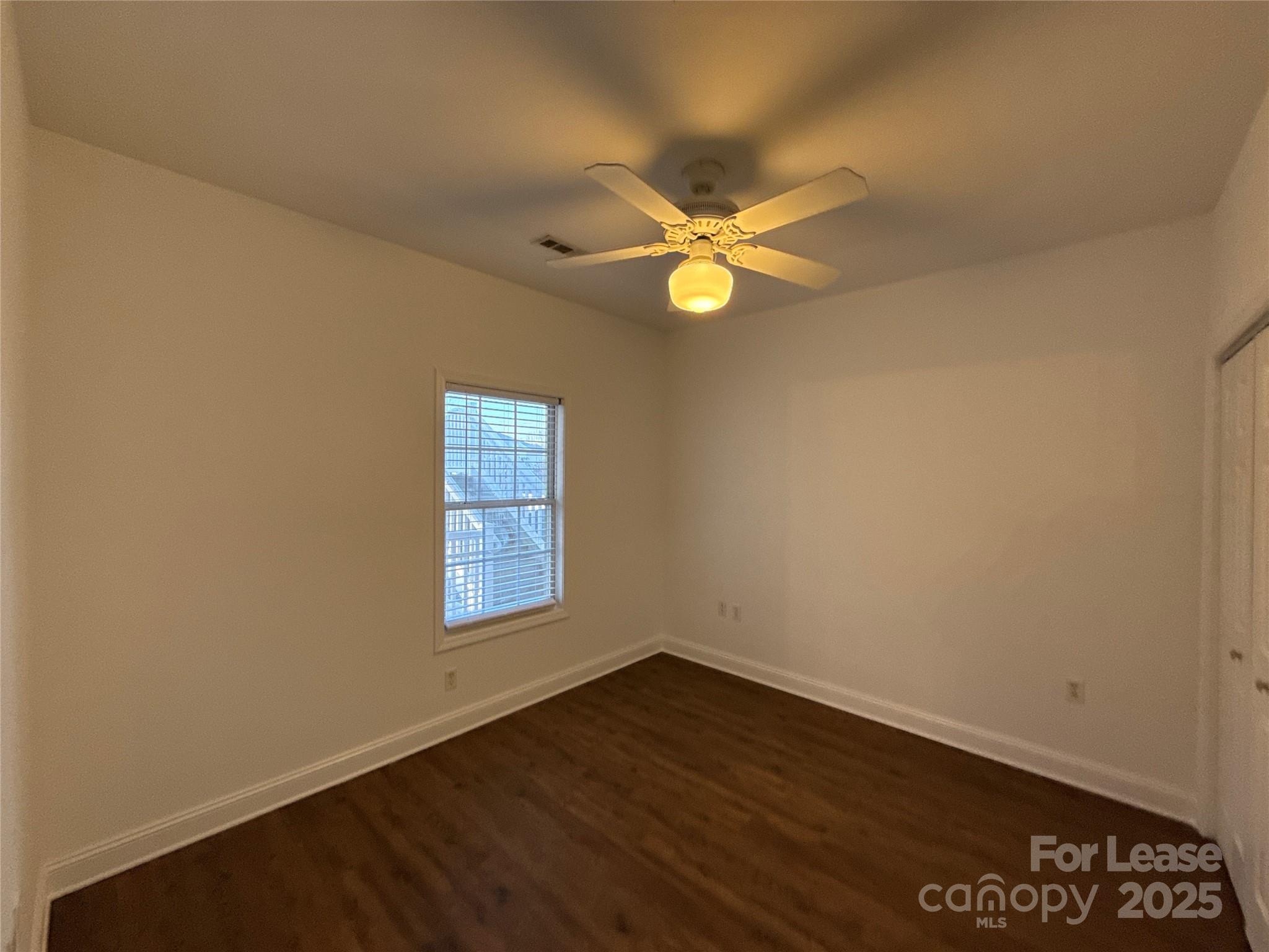 9068 Meadow Vista Road Charlotte, NC 28213 - Photo 9 of 13 an empty room with a window and ceiling fan