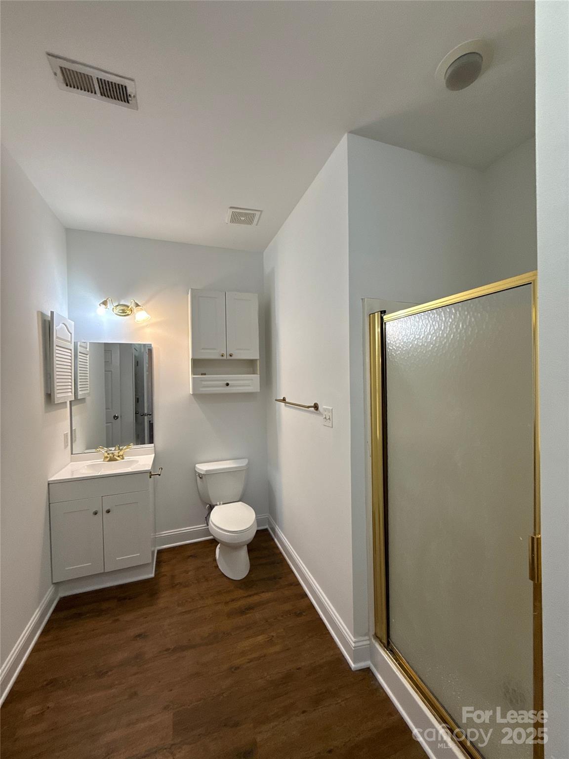 9068 Meadow Vista Road Charlotte, NC 28213 - Photo 10 of 13 a bathroom with a sink a toilet and shower