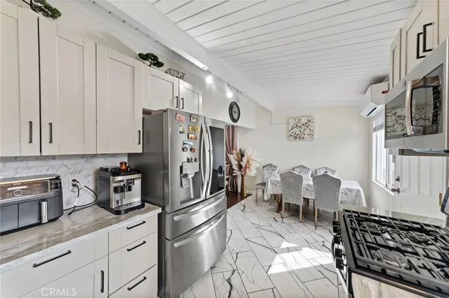 a kitchen with stainless steel appliances a refrigerator and cabinets