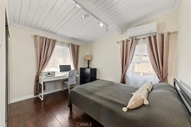 a bed sitting in a bedroom next to a window