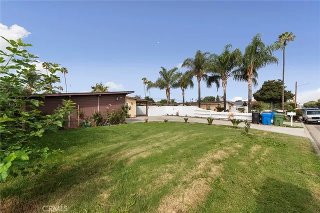 a view of a house with a backyard and a patio