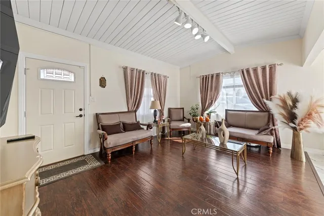 a living room with furniture window and wooden floor