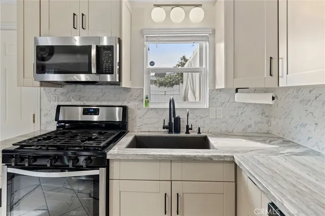 a kitchen with a stove and a white cabinets