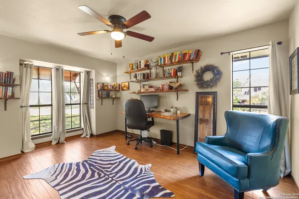 a view of a livingroom with workspace and a window