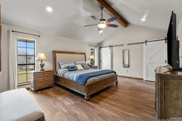 a bedroom with a bed and a flat screen tv