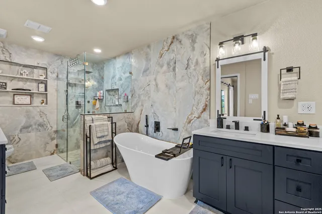 a bathroom with a double vanity sink mirror and shower