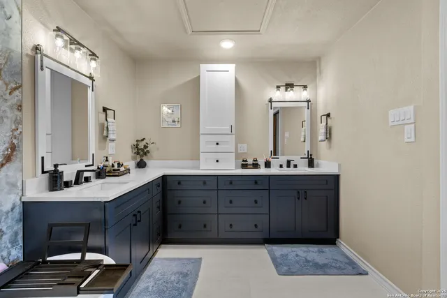 a bathroom with a sink double vanity and a mirror