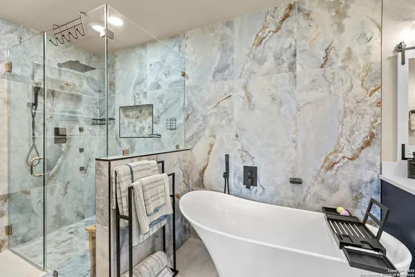 a bathroom with a bathtub and shower