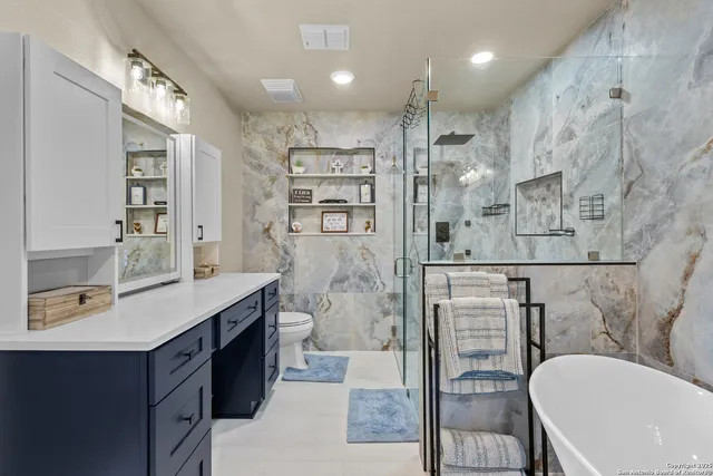 a bathroom with a double vanity sink mirror and shower