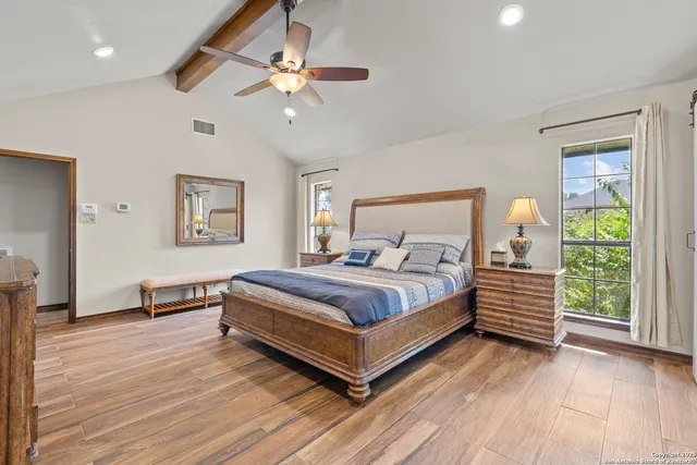 a bedroom with a bed lamp and a window