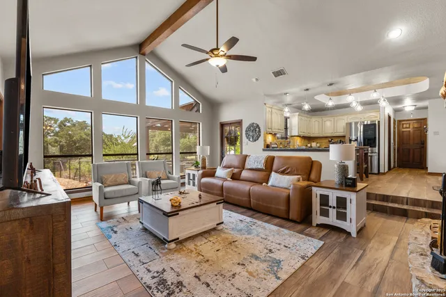 a living room with furniture and large windows
