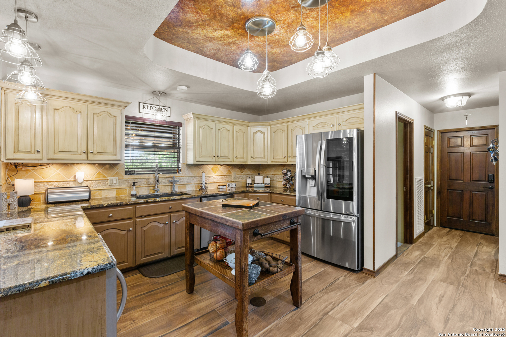 31421 Wild Oak Hill Fair Oaks Ranch, TX 78015 - Photo 21 of 50 a kitchen with stainless steel appliances granite countertop a sink refrigerator and cabinets