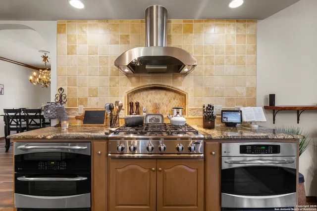 a stove top oven sitting inside of a kitchen