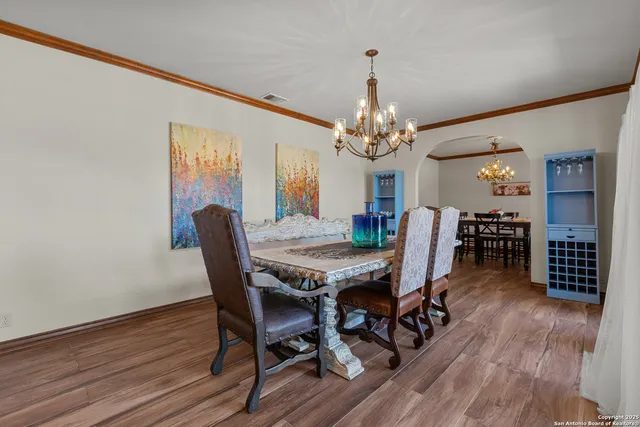 a dining room with furniture wooden floor and chandelier