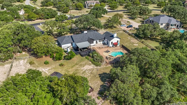 an aerial view of a house with a yard