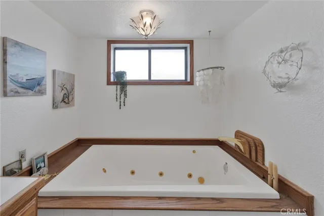 a view of a hallway with wooden floor and a chandelier