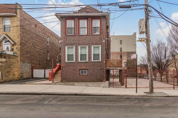 a view of a brick building next to a road