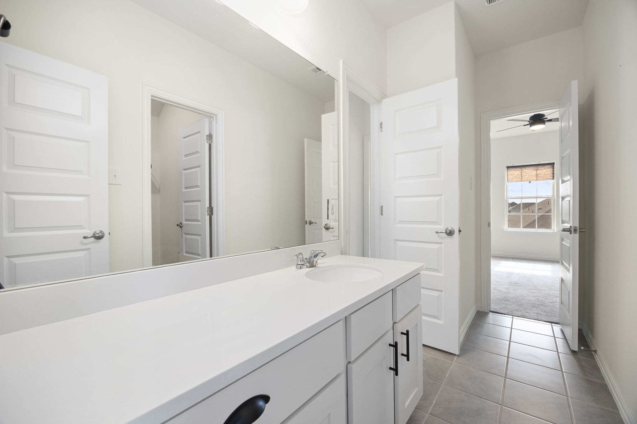 1098 Cherrystone Loop Buda, TX 78610 - Photo 26 of 37 a spacious bathroom with a sink and a mirror