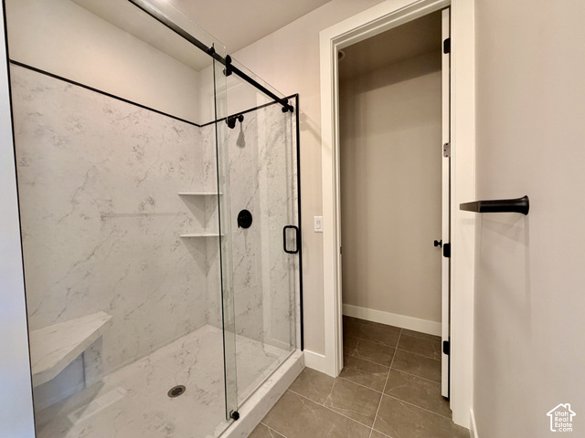 1595 West Canyon Rim Road, Unit 630 Lehi, UT 84048 - Photo 21 of 41 Glass-enclosed shower with a black-finish sliding door and integrated seating