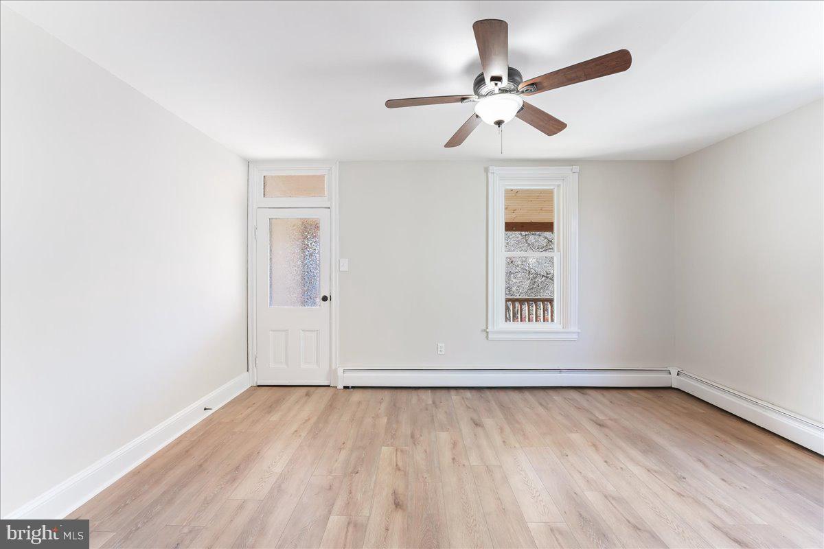 8 Convent Road Aston, PA 19014 - Photo 14 of 28 an empty room with wooden floor chandelier fan and windows
