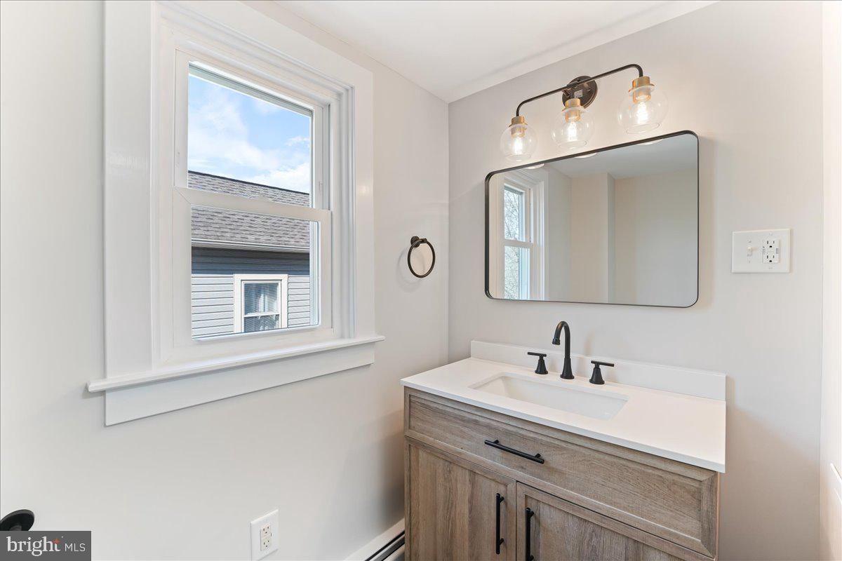 8 Convent Road Aston, PA 19014 - Photo 19 of 28 a bathroom with a sink and a mirror