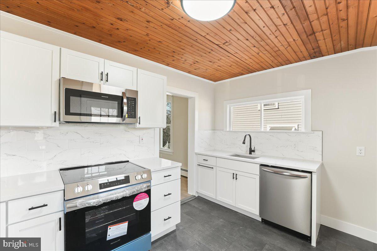 8 Convent Road Aston, PA 19014 - Photo 6 of 28 a kitchen with a stove and a microwave