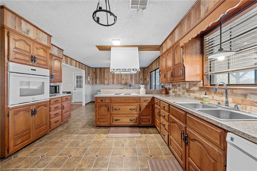 126 Cr 173 Road Marlin, TX 76661 - Photo 12 of 48 a large kitchen with stainless steel appliances granite countertop a sink and cabinets