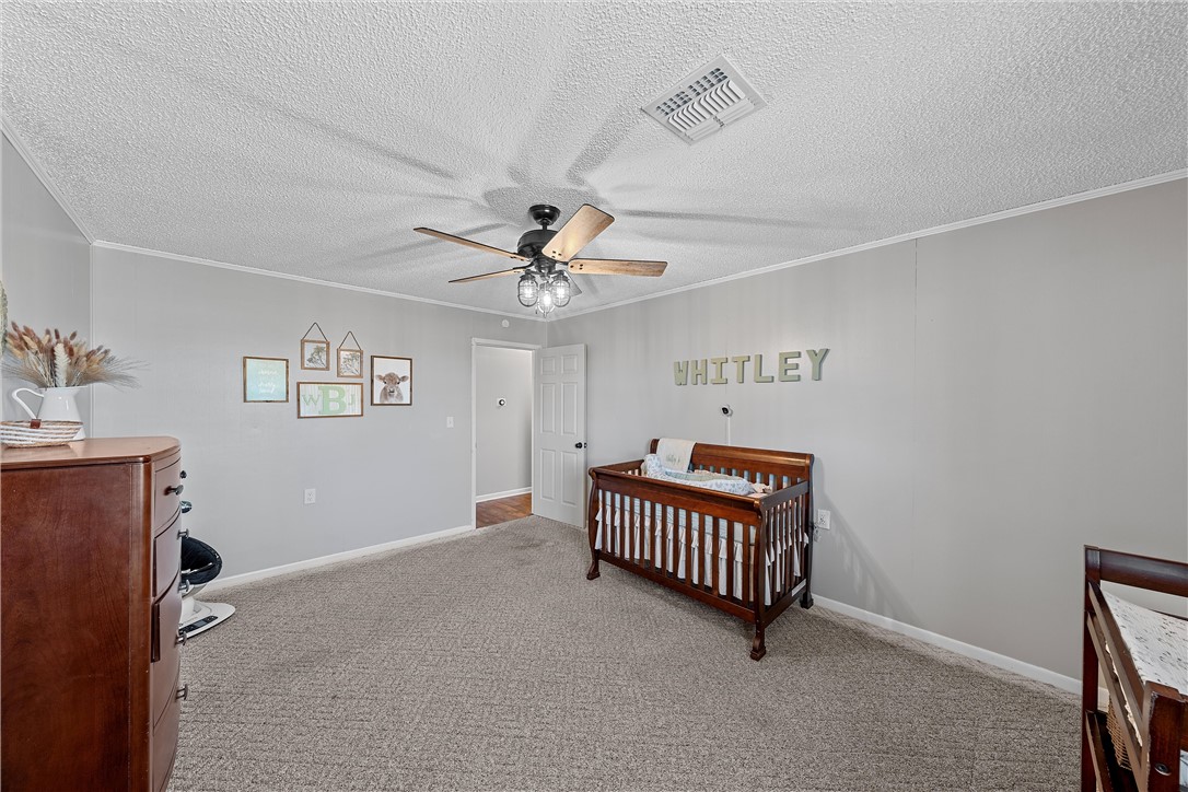 126 Cr 173 Road Marlin, TX 76661 - Photo 18 of 48 an empty room with windows and ceiling fan view